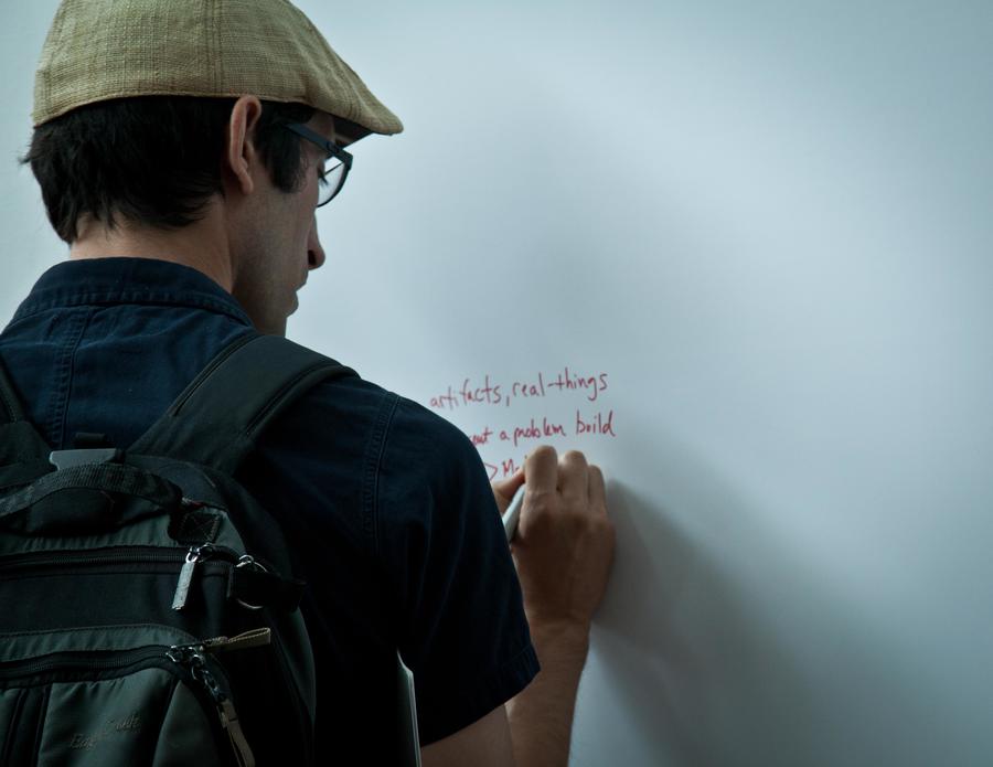 Attendee writing on white board