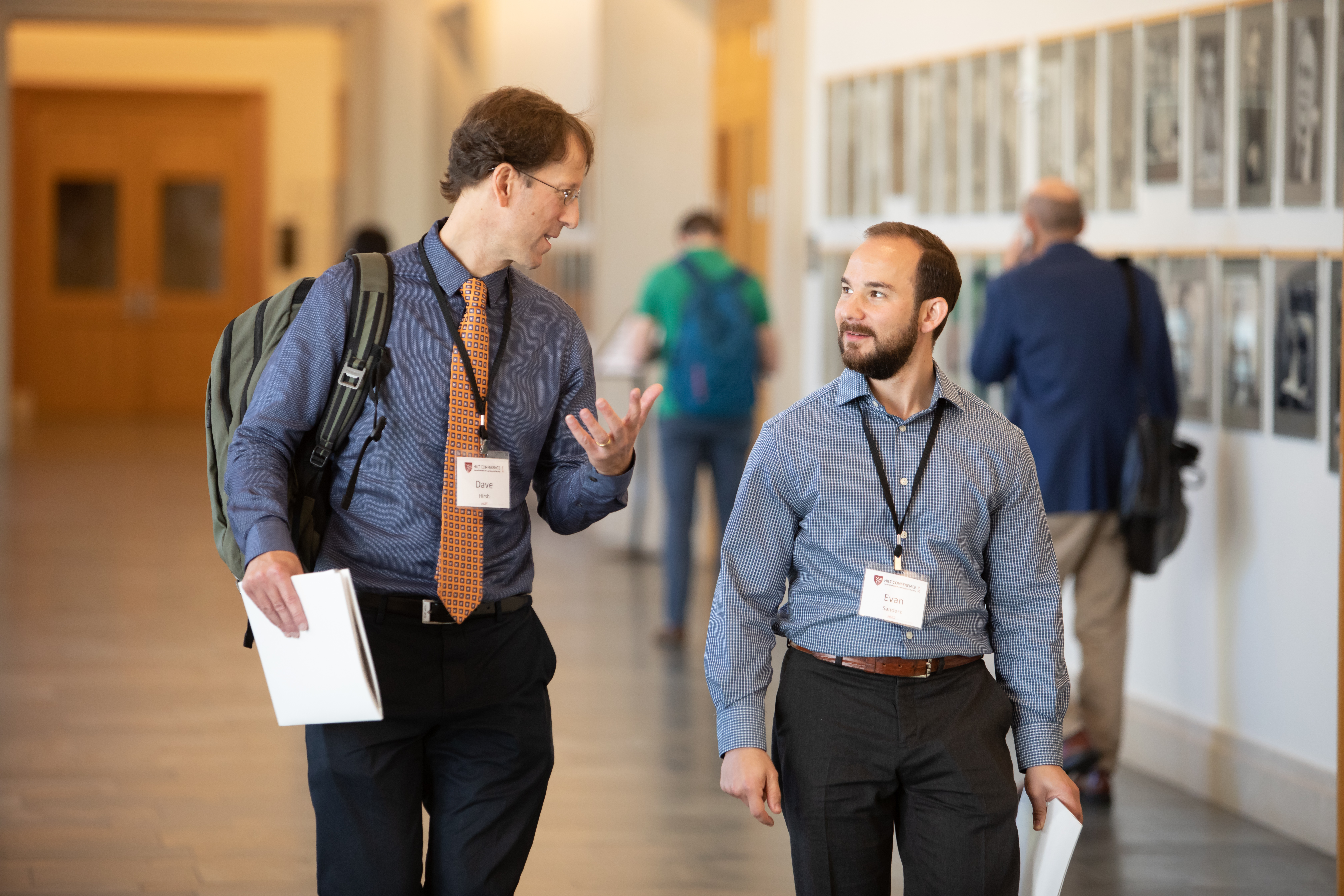 Two conference attendees walk while in conversation