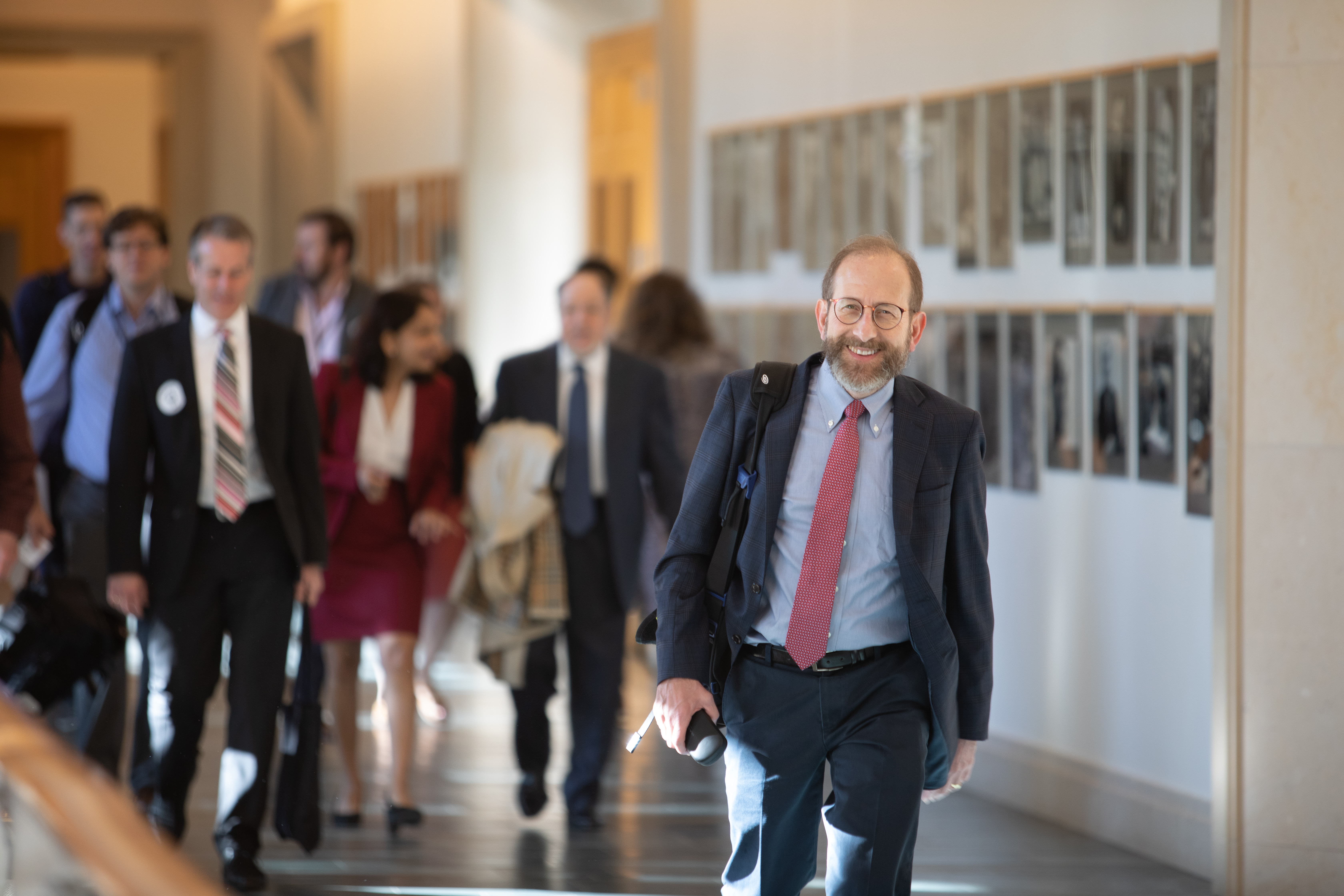 Provost Alan Garber walks into the conference center