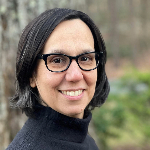 Emily Bottis smiling and wearing a black turtleneck sweater