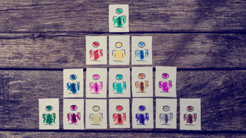 White cards with colorful stick figures stacked in a triangular layout.