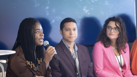Harvard students on a conference panel speaking