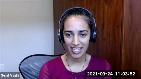 A woman wearing a purple shirt