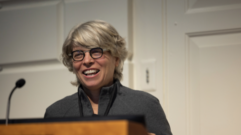 A woman with short white hair smiling