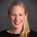 Mary Godfrey smiling brightly in a black top