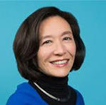 Kessely Hong's headshot in front of a bright ocean blue background.