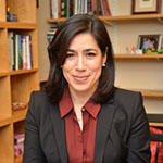 María Luisa Parra wearing a red shirt under a black blazer