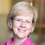 Allison Pingree smiling brightly in a pink shirt.