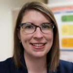 Amy Deschenes smiling brightly in her office