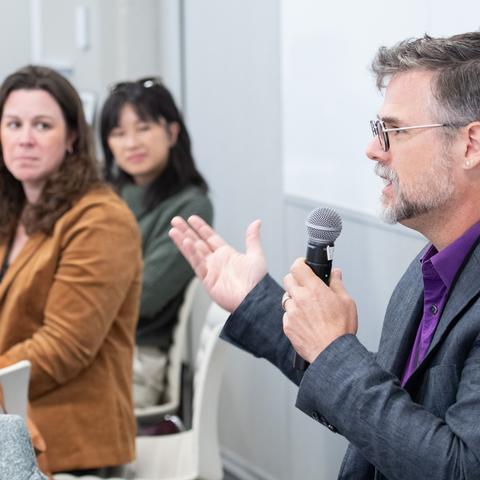 HILT 2025 Conference Speaker wearing a purple button down shirt under a gray blazer.