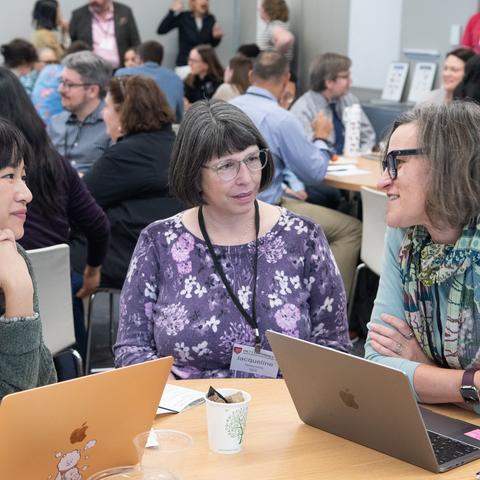 HILT Conference attendees networking together in a bright sunny room.