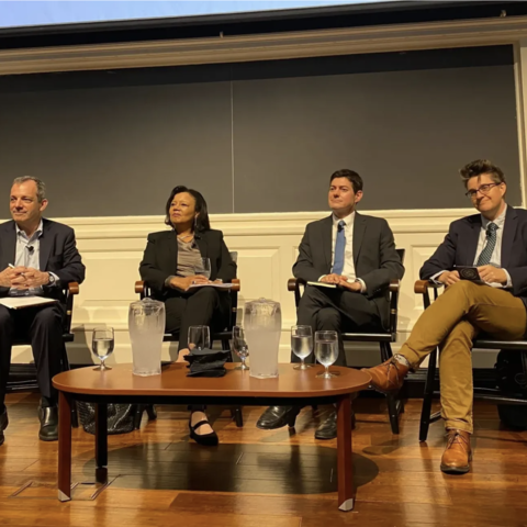A panel of educators on stage