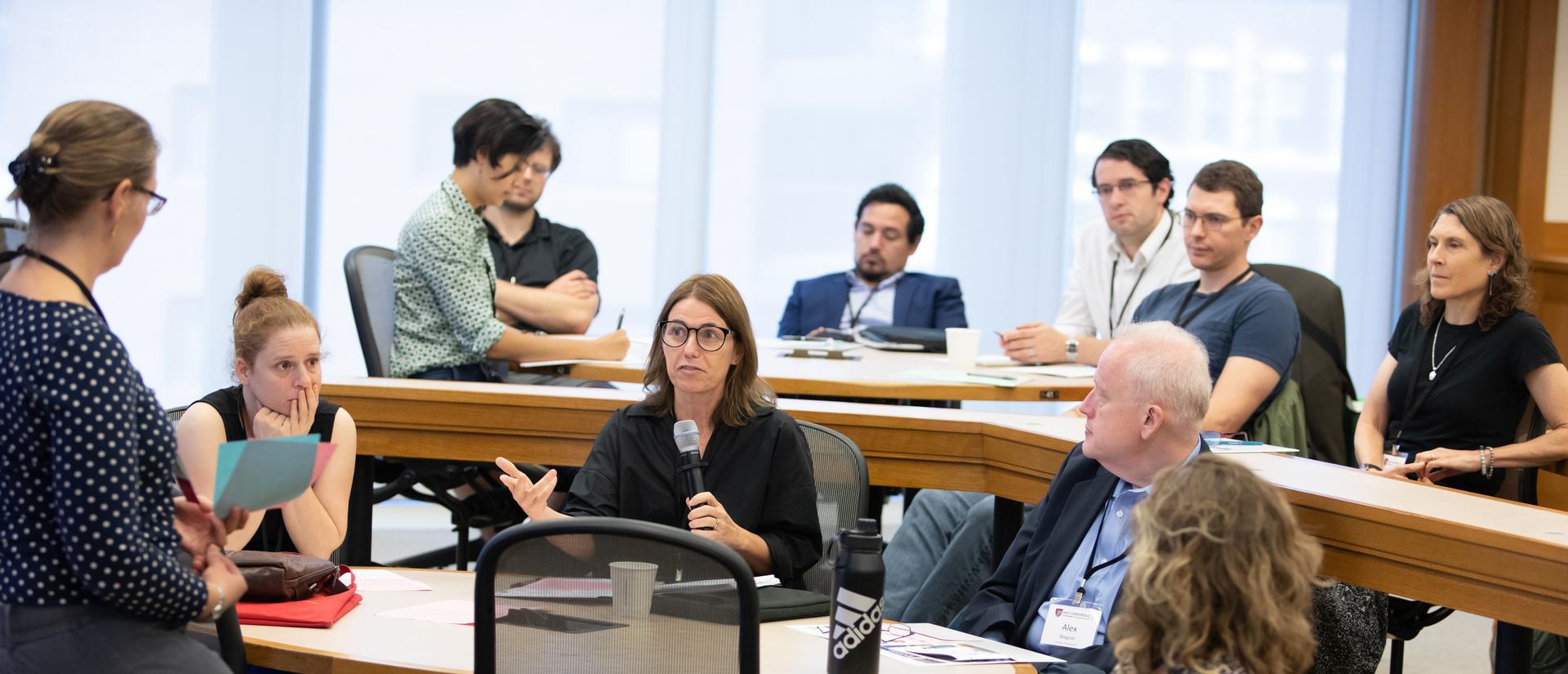 A 2019 HILT Conference breakout session with participants gathered around a table