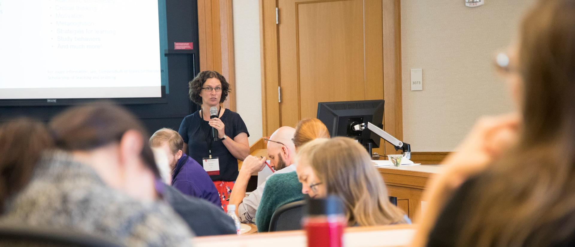 A room full of Harvard educators participating in a conference breakout session.