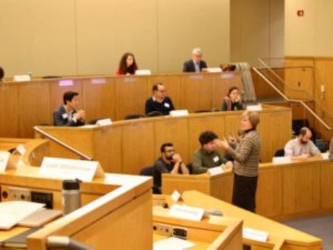 People sitting in a sunny lecture hall. 