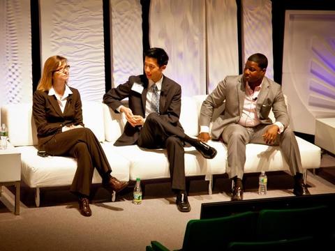 Three colleagues sitting on a white couch