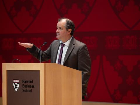 Dustin Tingley speaking at a podium