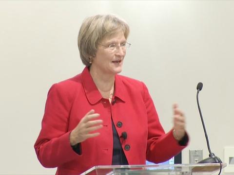 A woman wearing a bright red blazer