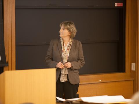 A woman standing by a podium