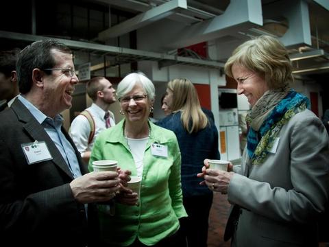 Three people having a joyful conversation