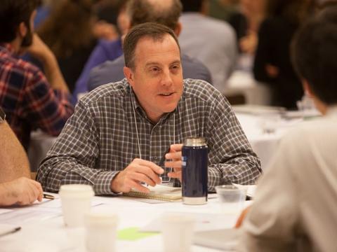 A man sitting at round table 