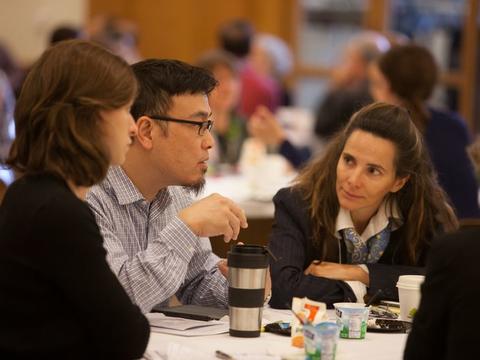 Colleagues talking at a round table