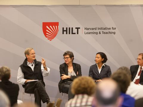 A panel of educators on stage