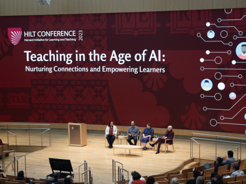 A powerpoint presentation displayed on a HBS stage