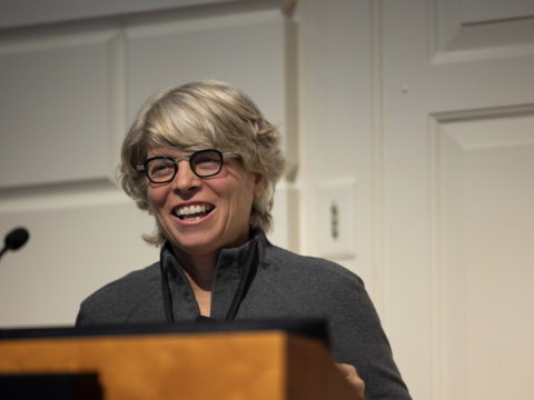 A woman with short white hair smiling