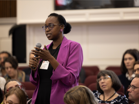 A woman wearing a bright purple blazer
