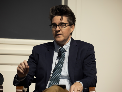 A person with short hair wearing a tie