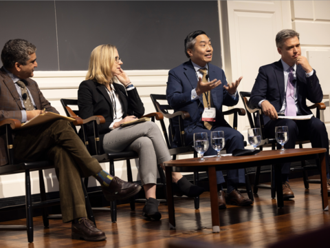 A panel of educators on stage
