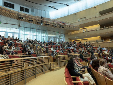 A packed conference room with Harvard educators