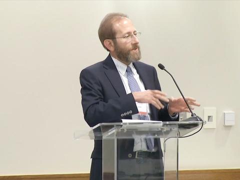 Allan Garber speaking into a microphone