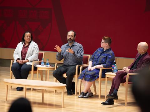 A panel of educators on stage