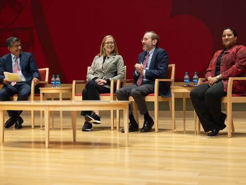 A panel of Harvard educators on stage