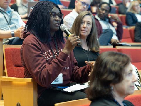 A woman talking into a microphone 