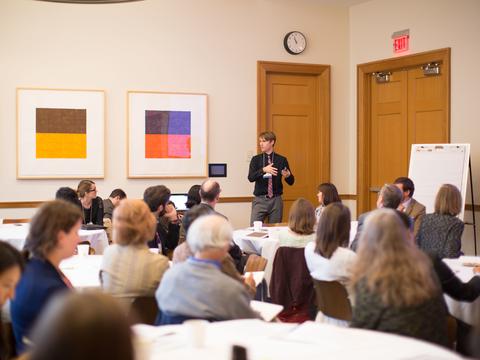 A group of educators in a large sunny room