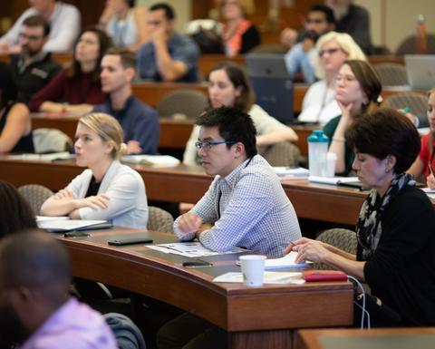 People sitting in a classroom watching a presentation