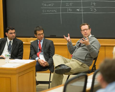 HILT 2016 panelist holding a discussion in a Harvard classroom with chalkboards.