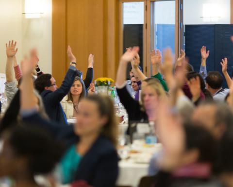 HILT Conference attendees raising their hand.
