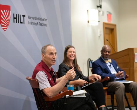 A panel of educators on stage