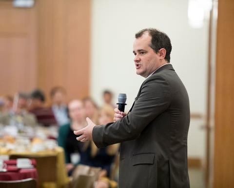 Dustin Tingley speaking into a microphone.