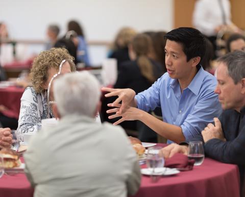 HILT 2017 Conference attendees networking at a round table that is draped with a red table cloth.