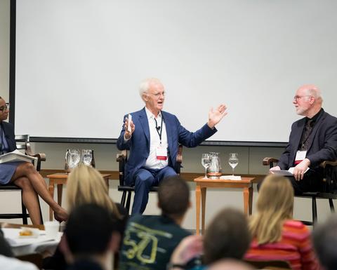 Three HILT 2018 Conference panelists on stage holding a discussion.