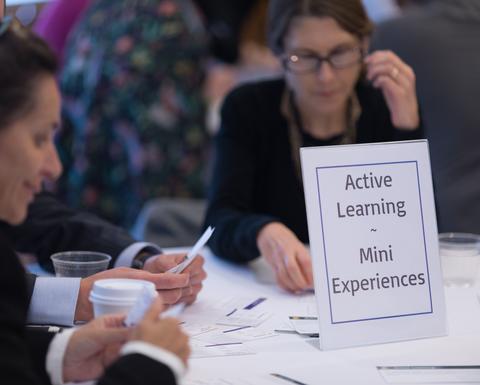 HILT 2017 Conference table with a sign that says "Active Learning Mini Experiences".