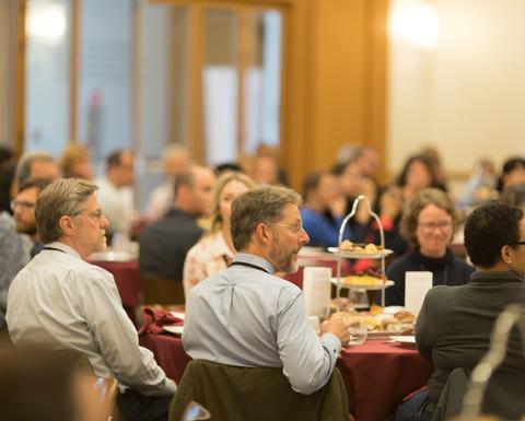 HILT 2017 Conference attendees sitting at various round tables with red table cloths. 