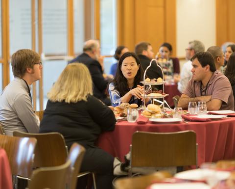 HILT 2017 Conference attendees sitting at various round tables with red table cloths. 