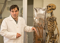 Terence Capellini standing next to a human skeleton