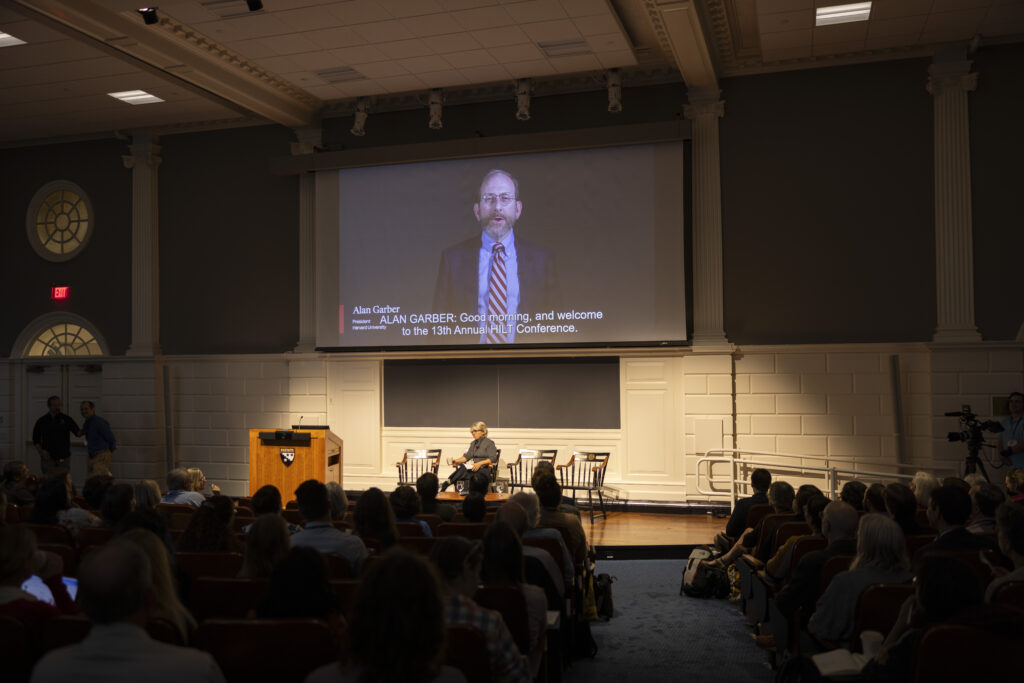 A video playing of Harvard President Alan Garber